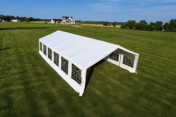 Backyard party setup with a white tent and round tables
