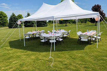 Aerial view of banquet tables under a white event tent