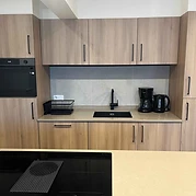 Kitchen with oven and coffee machine