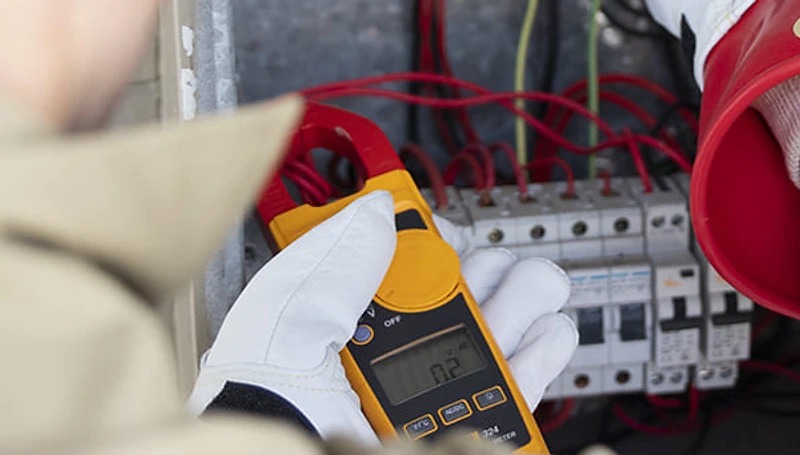 Professional electrician working on a modern switchboard in Sydney