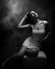 Black and white portrait of a woman seated amid swirling smoke