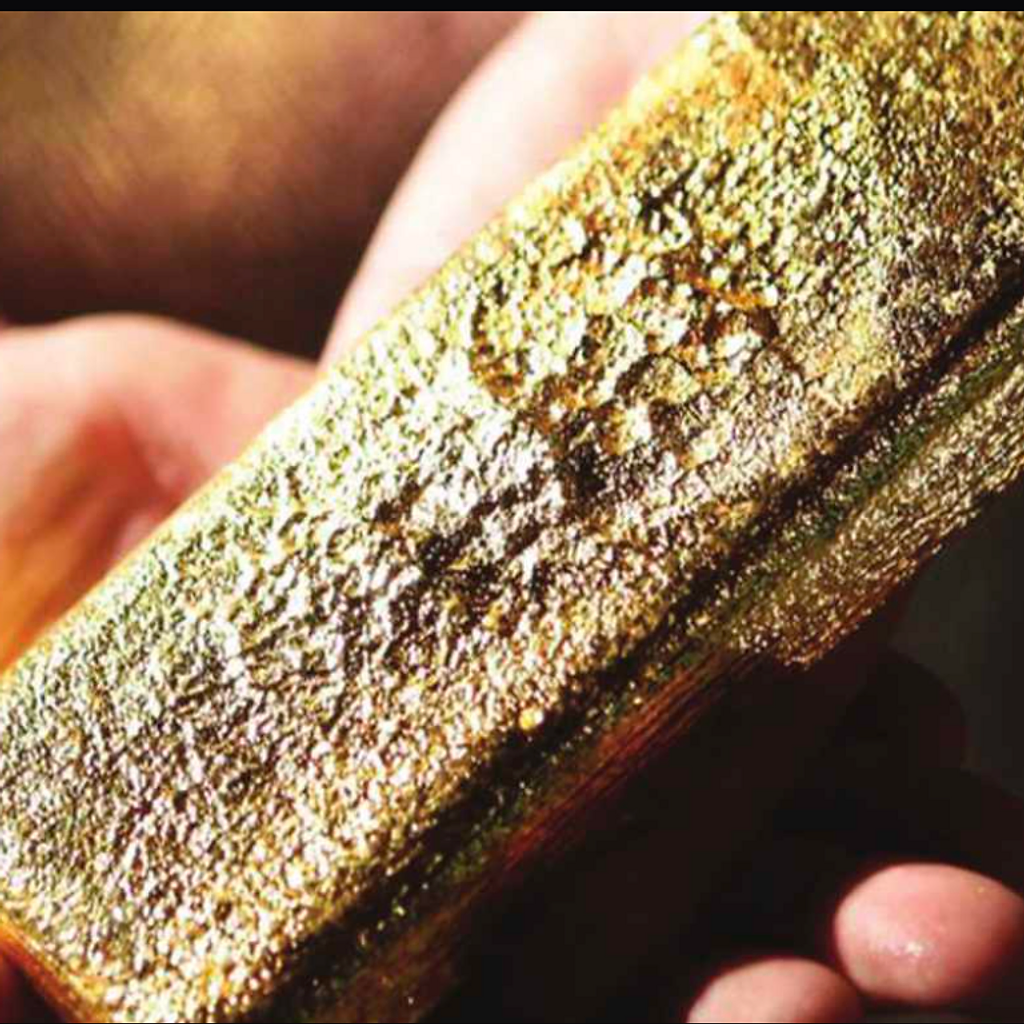 A gold bar held in hand