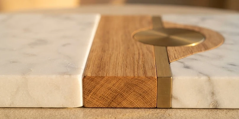 Marble, timber and brushed brass building materials in geometric composition