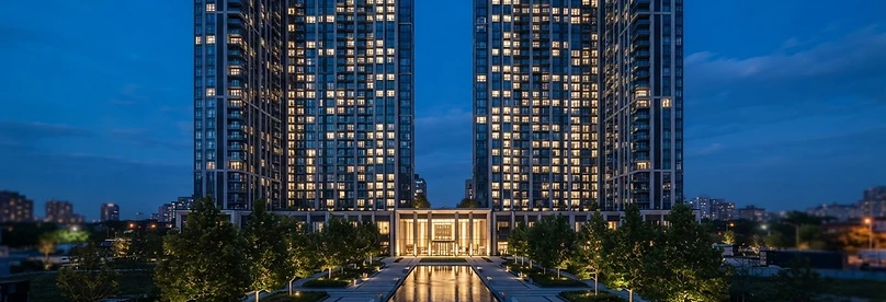 Modern residential development at blue hour with glowing interiors