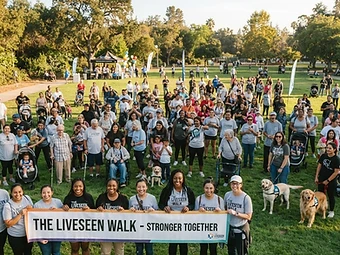 A diverse community gathered in a sunlit park for the inaugural LiveSeen Walk