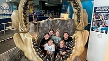 Students inside a megalodon jaw exhibit