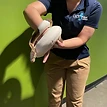 An OdySea Aquarium educator holds a snake for students