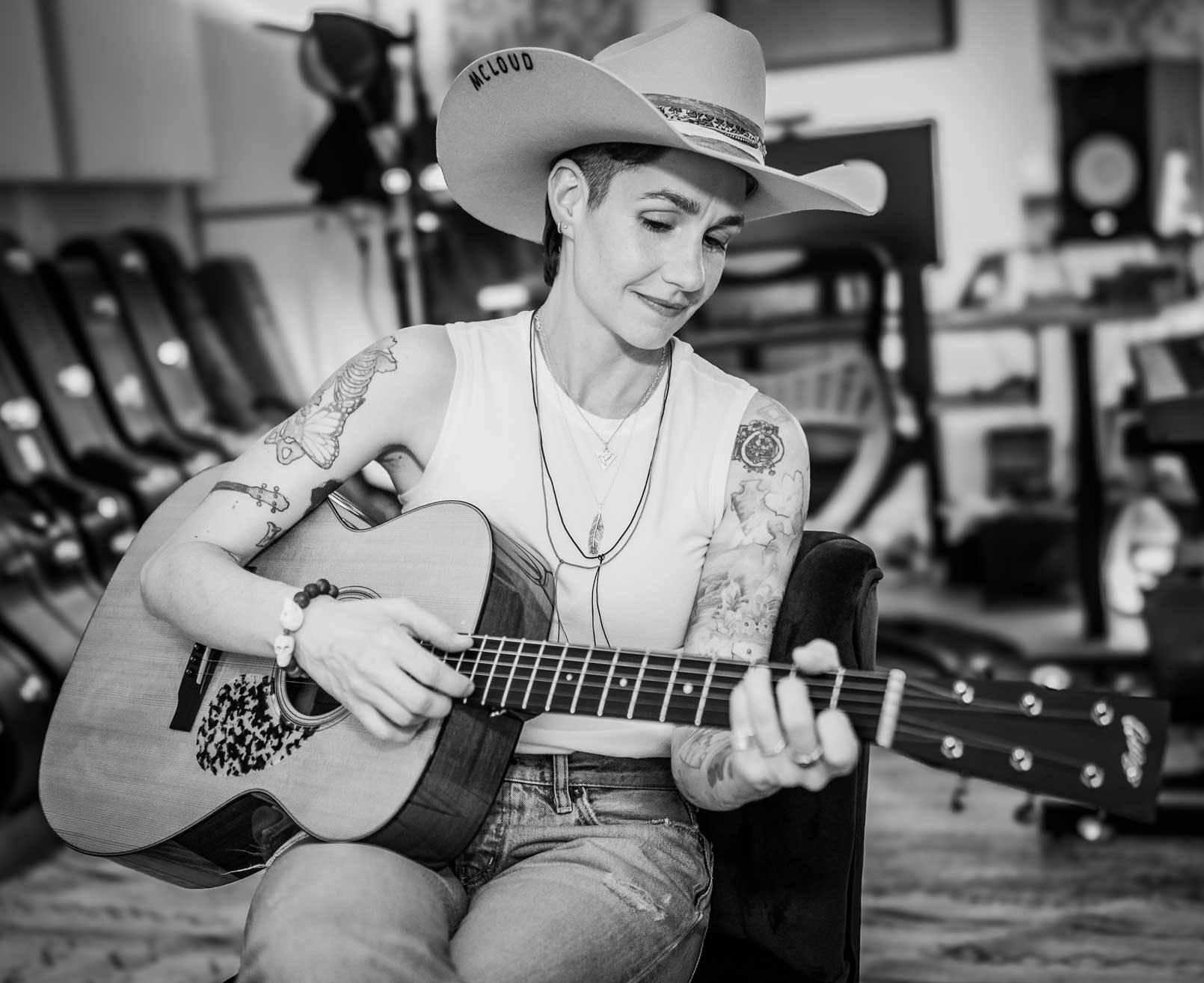 Emily McLoud black and white studio session with cowboy hat, guitar, focused