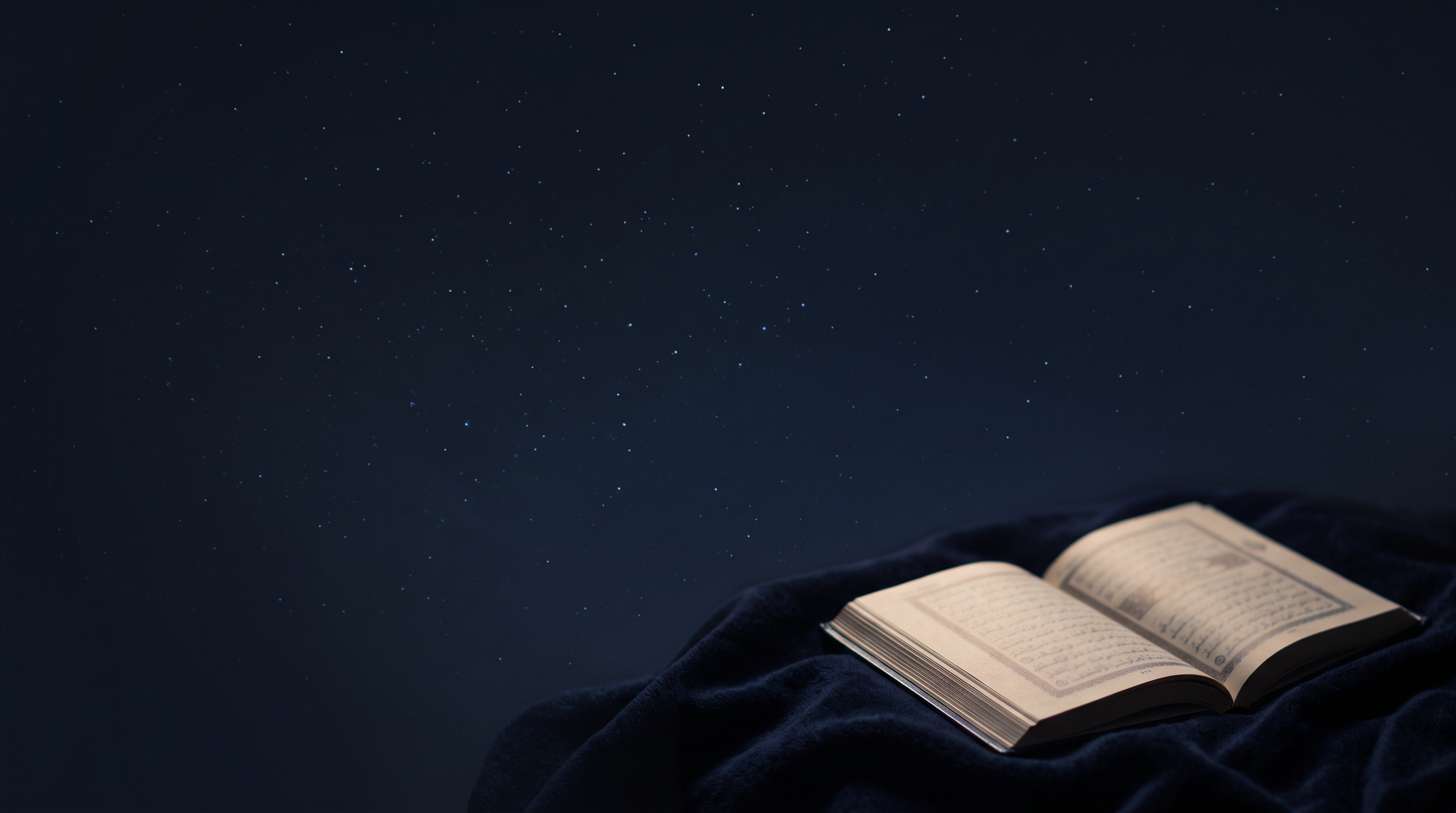 Laptop showing a live Qur’an class beside an open Qur’an