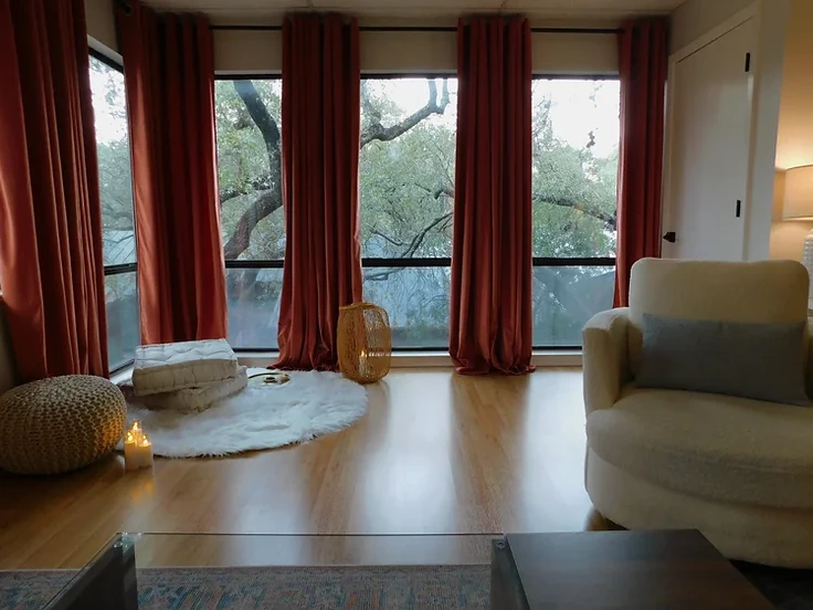 Calm corner with an armchair, floor cushions and a window in a private San Antonio therapy office
