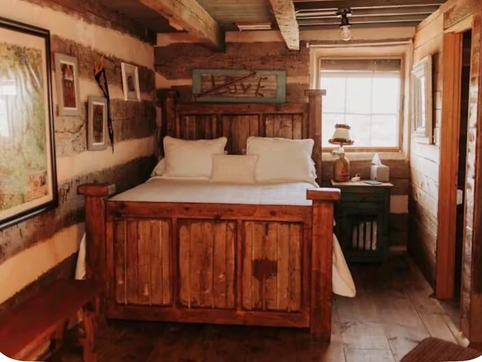 Private bedroom with a queen bed and LOVE sign at Camp Milagro retreat property