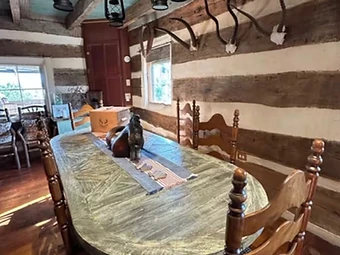 Long wooden dining table in the communal dining room at Camp Milagro