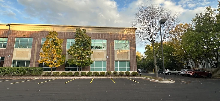 AtomicMedX building exterior with yellow autumn foliage