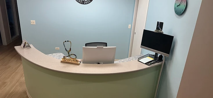 AtomicMedX reception desk with clinic logo