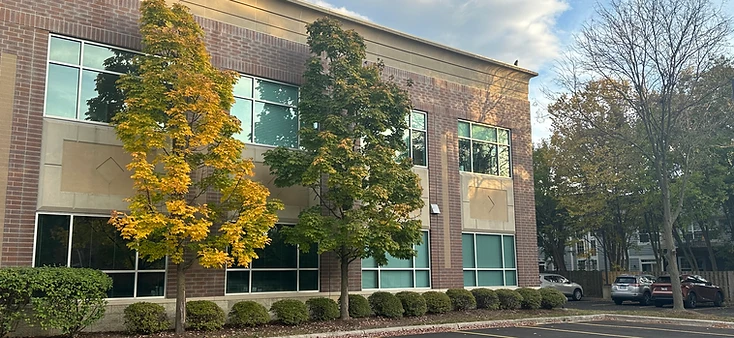 AtomicMedX clinic building exterior with autumn trees