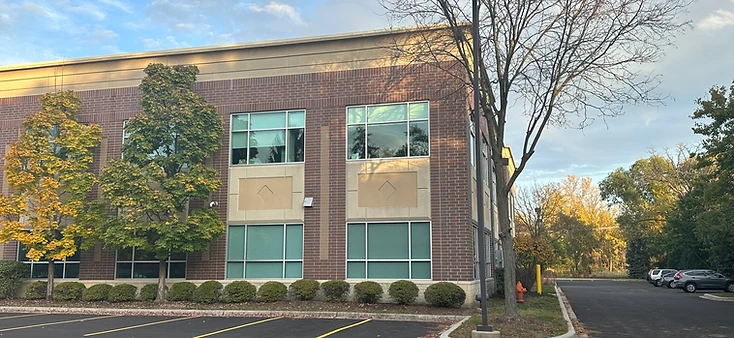 AtomicMedX building exterior with landscaped shrubs