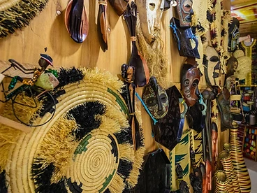 Traditional African masks, woven baskets and wooden carvings displayed at a Kigali craft shop