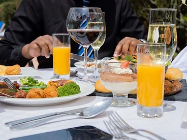 A Rwandan lunch service with local cuisine, fresh juice and dessert at an upscale Kigali hotel
