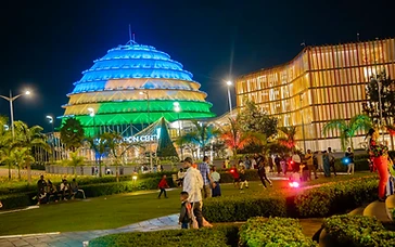 The Kigali Convention Centre illuminated at night with its iconic dome