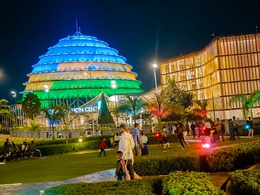 The Kigali Convention Centre illuminated at night with its iconic dome