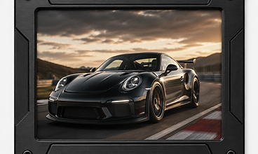 Anodized black frame housing a Porsche 911 GT3 at sunset