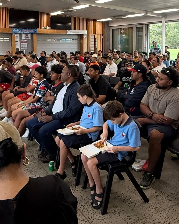 Pasifika and Māori college youth walking together on a campus pathway, side by side