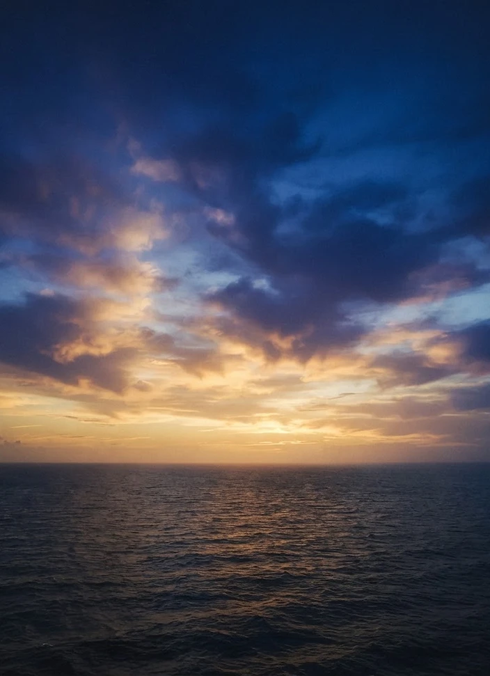 A serene golden twilight sky above the horizon