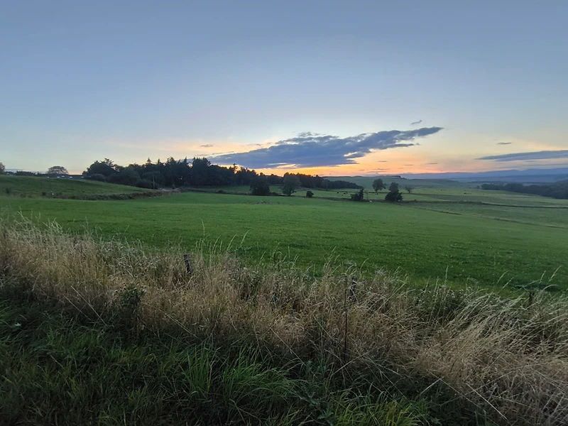 A misted Perthshire valley at first light, framed by the Ochil Hills