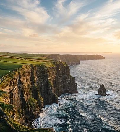 Emerald fields meeting the Atlantic coastline of west Ireland at golden hour