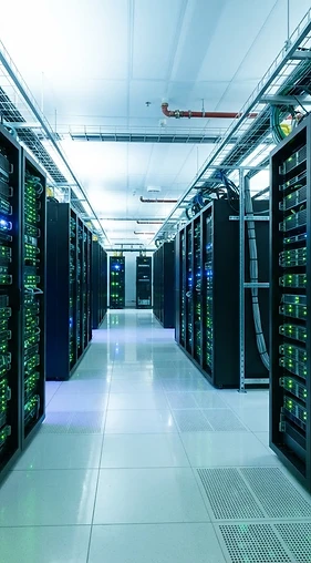 A modern datacenter corridor with glowing green server lights