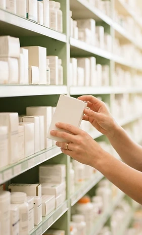 Neatly organised pharmacy shelves in bright natural light