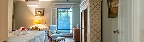 Green bedroom with desk and blue armchair