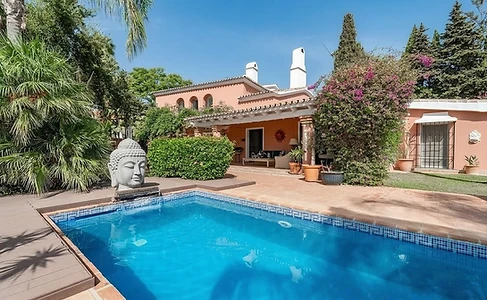 Pool and stone fountain beside the villa