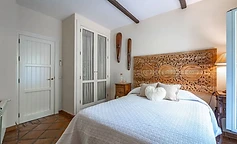 Bedroom with mandala headboard and antique furniture