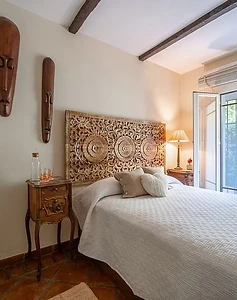 Carved headboard with wooden masks