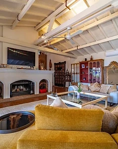 Fireplace and mustard sofa in the main living room