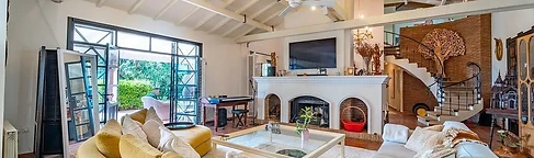 Mustard sofa facing the arched fireplace
