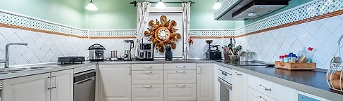 U-shaped kitchen with dark wooden beams