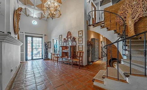 Entryway with curved staircase and crystal chandelier