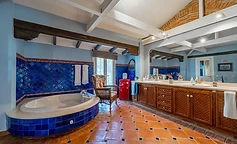 Bathroom with tub and blue diamond tiles
