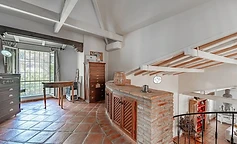 Landing with white beams and iron staircase