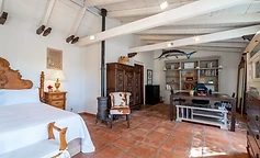 Bedroom with desk, iron stove and bookcase
