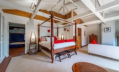 Four-poster bed with arch lamps and benches