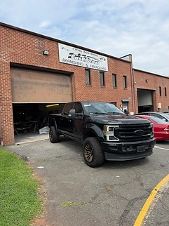 Black Ford Super Duty completed repair at East Coast Auto Refinishing & Fiberglass