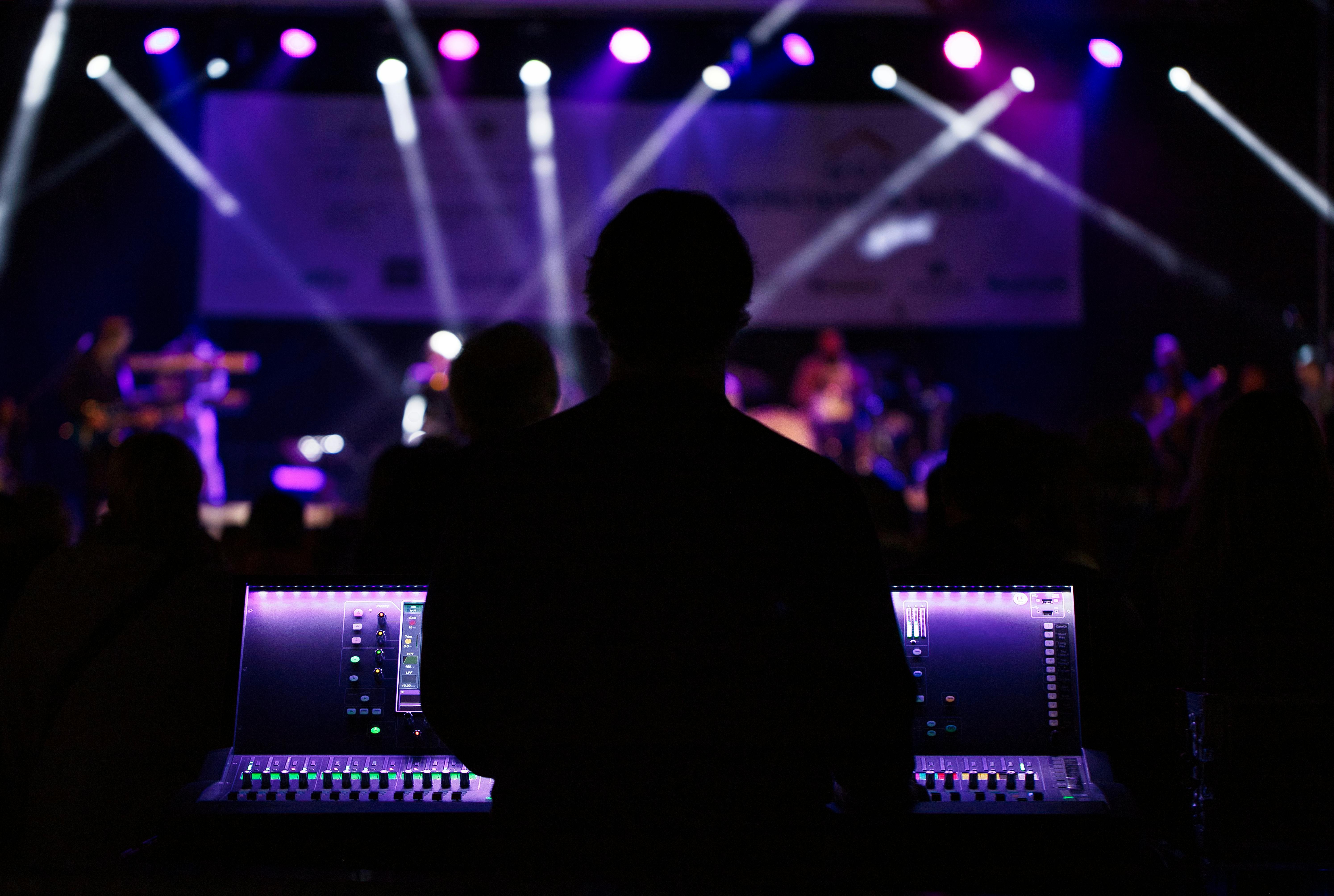 Hurricane Productions crew running a live corporate event under blue stage lighting