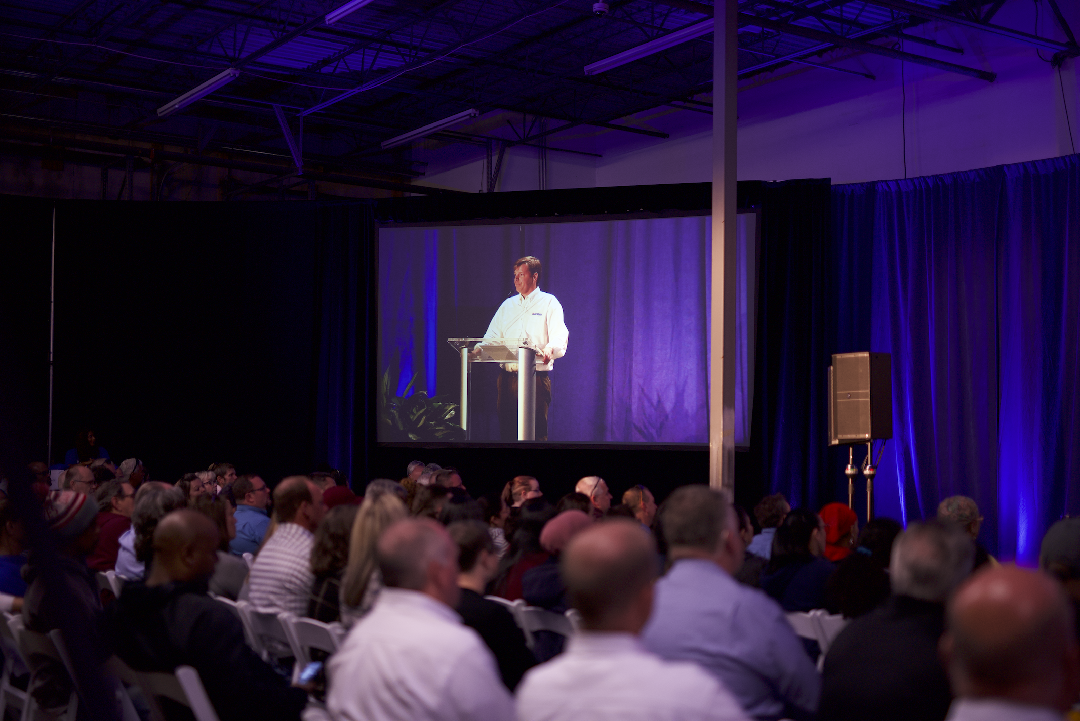 Attendees seated at a conference table during a Hurricane Productions event