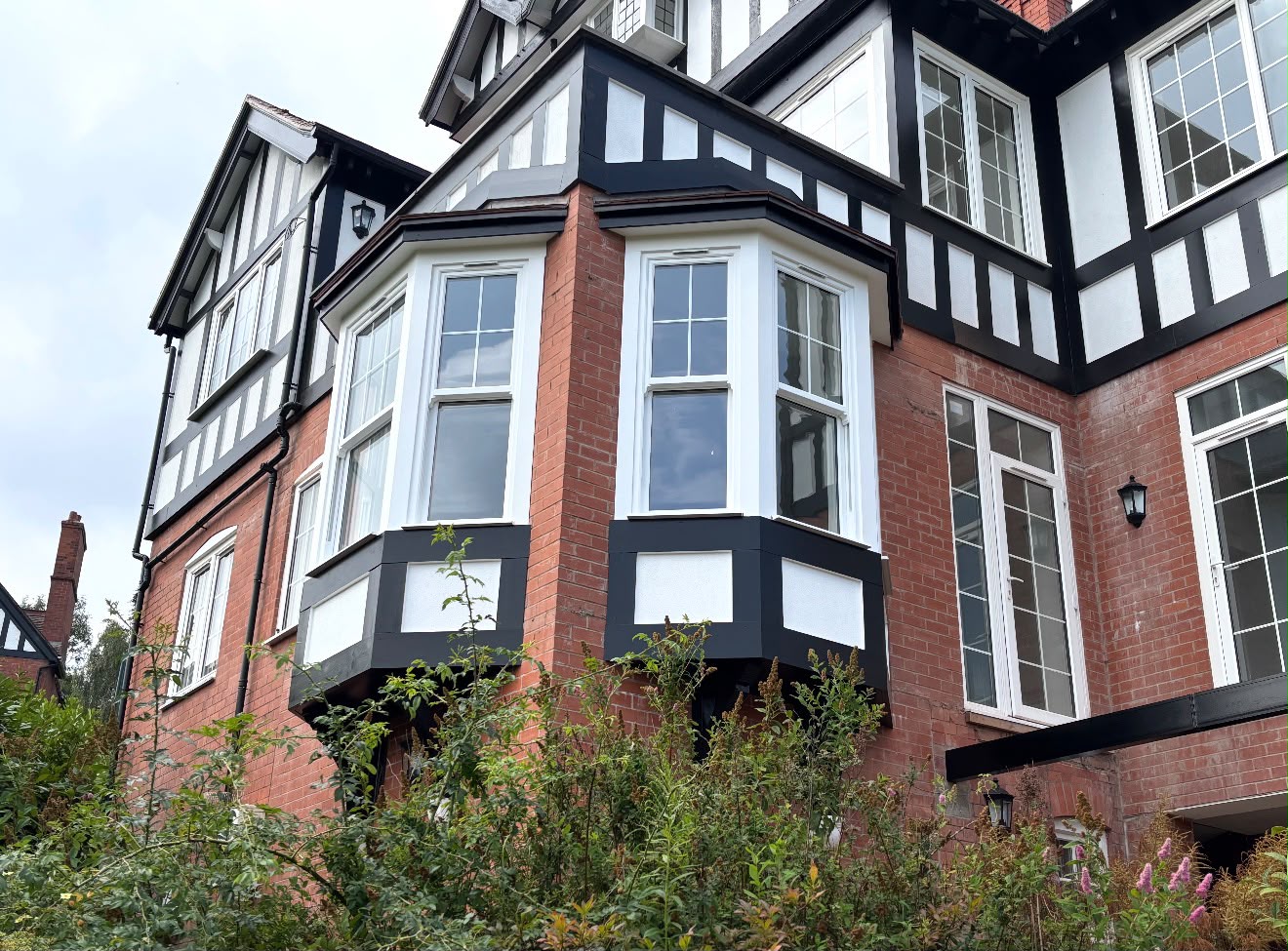 Renovated Tudor-style property with restored brickwork and timber framing