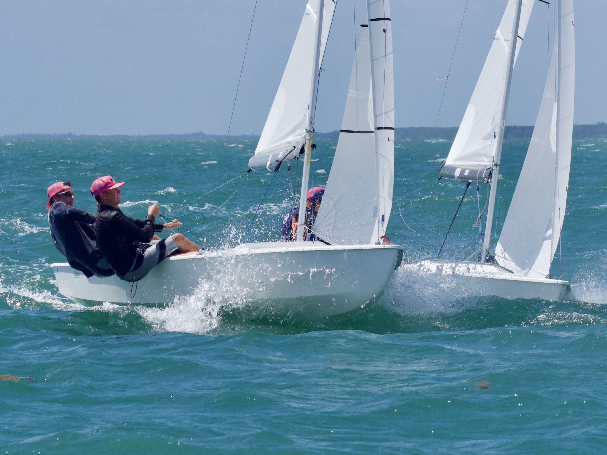 Sailing crew navigating wind, waves, and competing boats