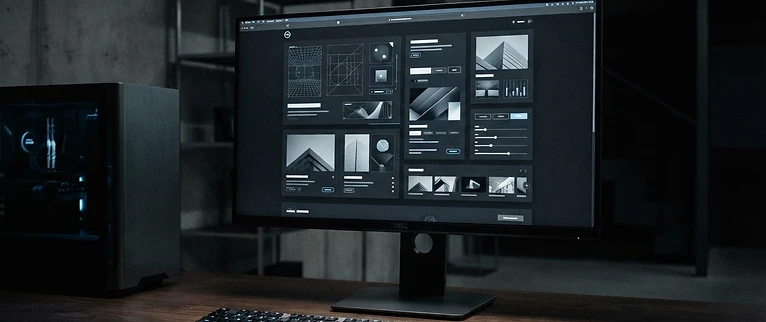 Just Fencing WA website displayed on a matte-black monitor in a dim studio
