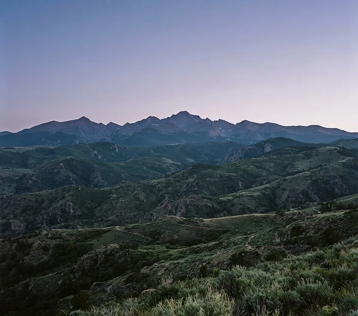 Colorado Front Range mountain ridgeline at dusk in soft alpenglow light